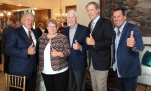 Dr. Thornton standing with Gary Kubiak, RC Slocum, and other donors at the donor party